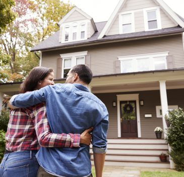 Rear View Of Loving Couple Walking Towards House