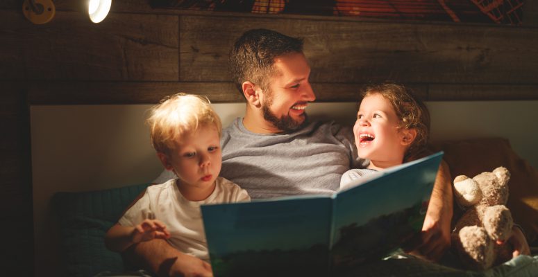 evening family reading. father reads children . book before going to bed