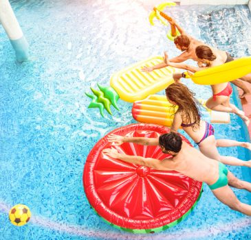 Top view of active friends jumping at swimming pool party – Vacation concept with happy guys and girls having fun in summer day at luxury resort – Dynamic young people on warm bright sunshine filter
