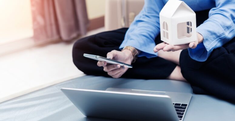 loan-planing-for-new-home-concept-businesswoman-holding-home-model-and-mobile-with-laptop-on-bed-at_t20_vKznWv (1)